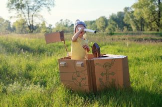 Toddler,Girl,Playing,With,Paperboard,Ship